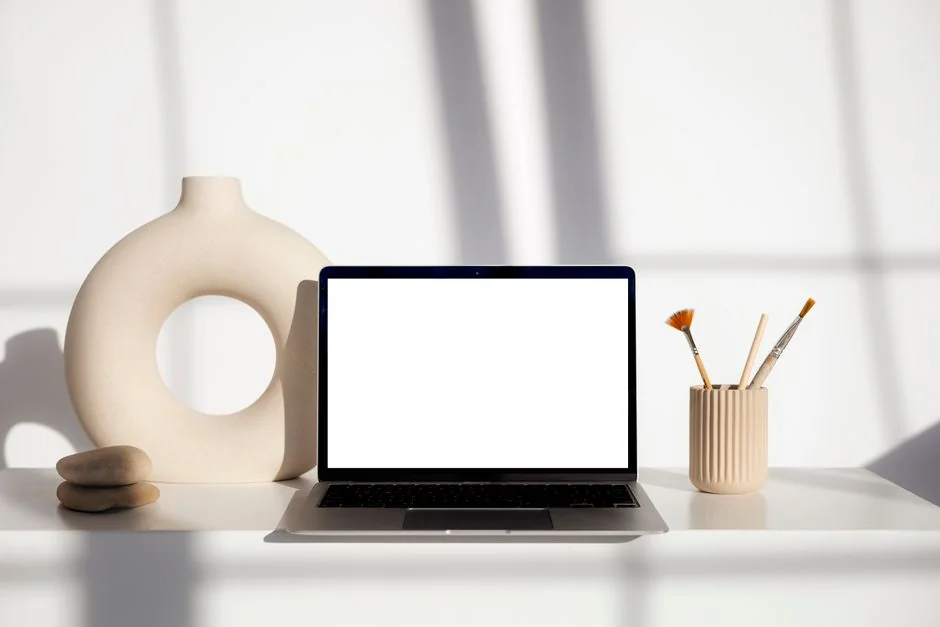 Close-up of an artist designing fashion sketches while seated at a desk indoors.